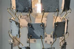 Chandelier made with ceramic tiles and brass hooks